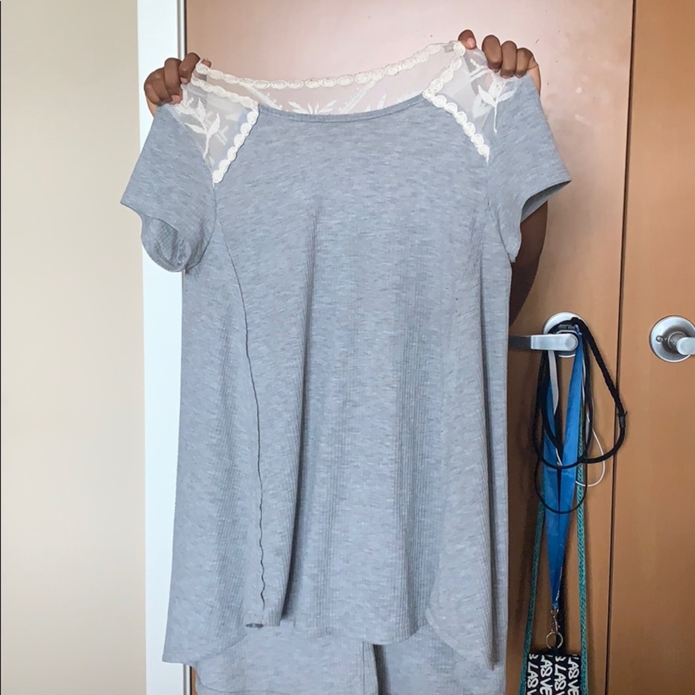A gray blouse with a white flower design.